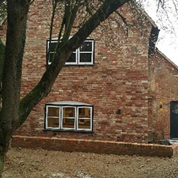 red brick house and tree