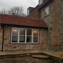 red brick house with sage window