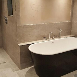 a tiled bathroom and bath
