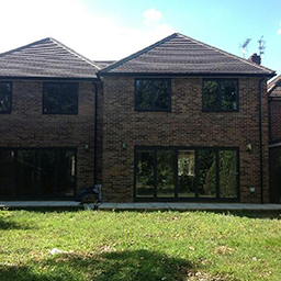 house with a glass door leading onto a garden